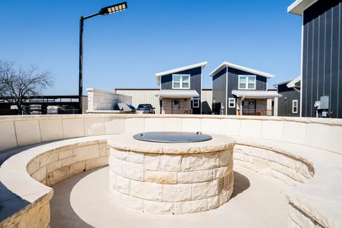 The limestone fire pit and its curved seating wall