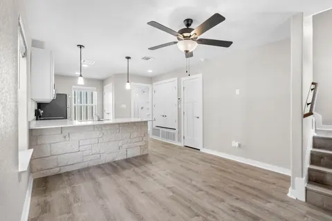 The living room and kitchen, unfurnished