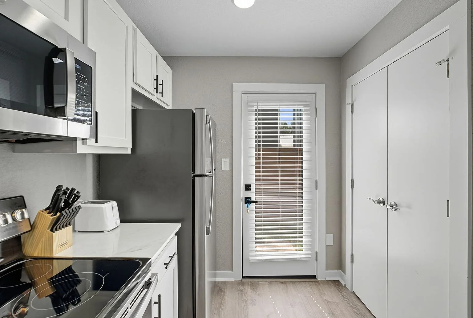 Kitchen range toward back door, 20 Tate Lane, Round Rock