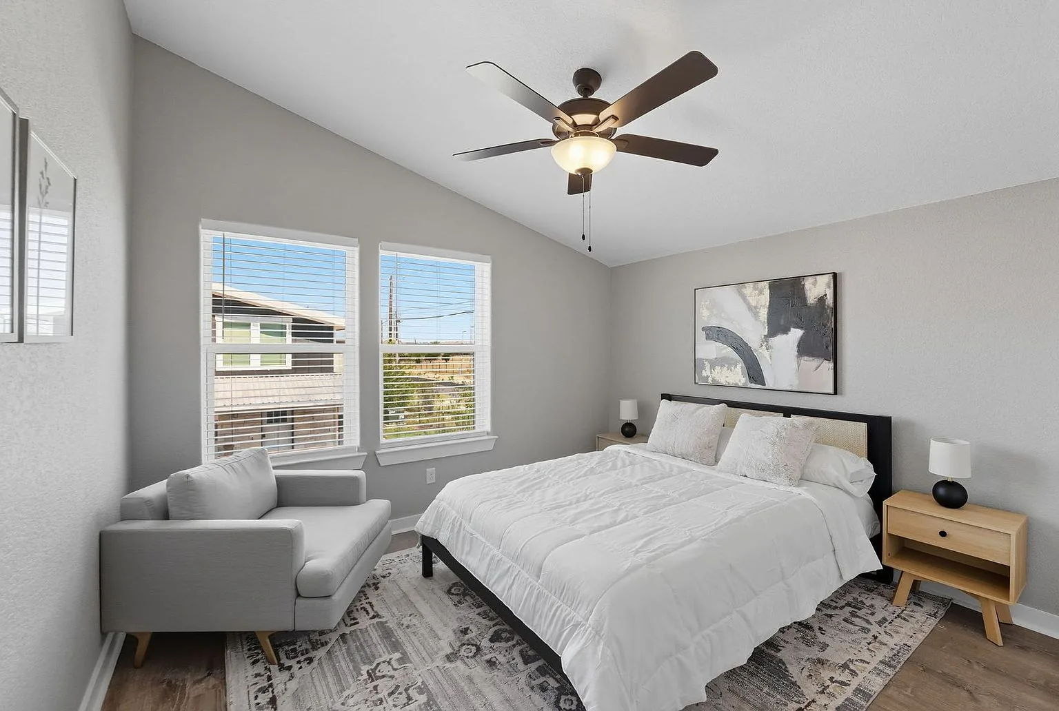 Upstairs bedroom with a vaulted ceiling, furnished with a queen bed