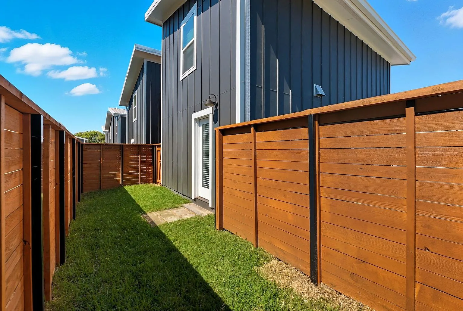 A private back yard at 20 Tate Lane, fenced in horizontal six-foot cedar with new sod