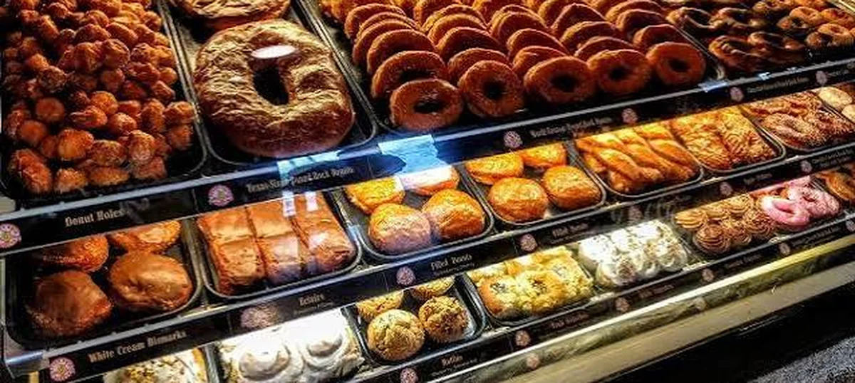 The display case at Round Rock Donuts, filled with trays of doughnuts