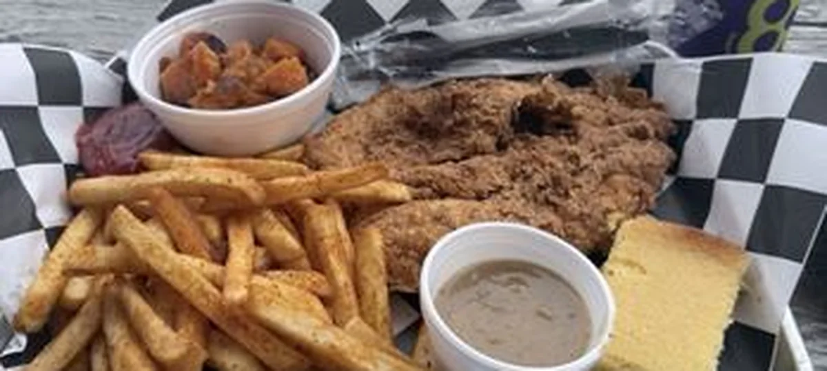 A fried plate with chips, cornbread and gravy in a basket at Nana B’s Country Kitchen