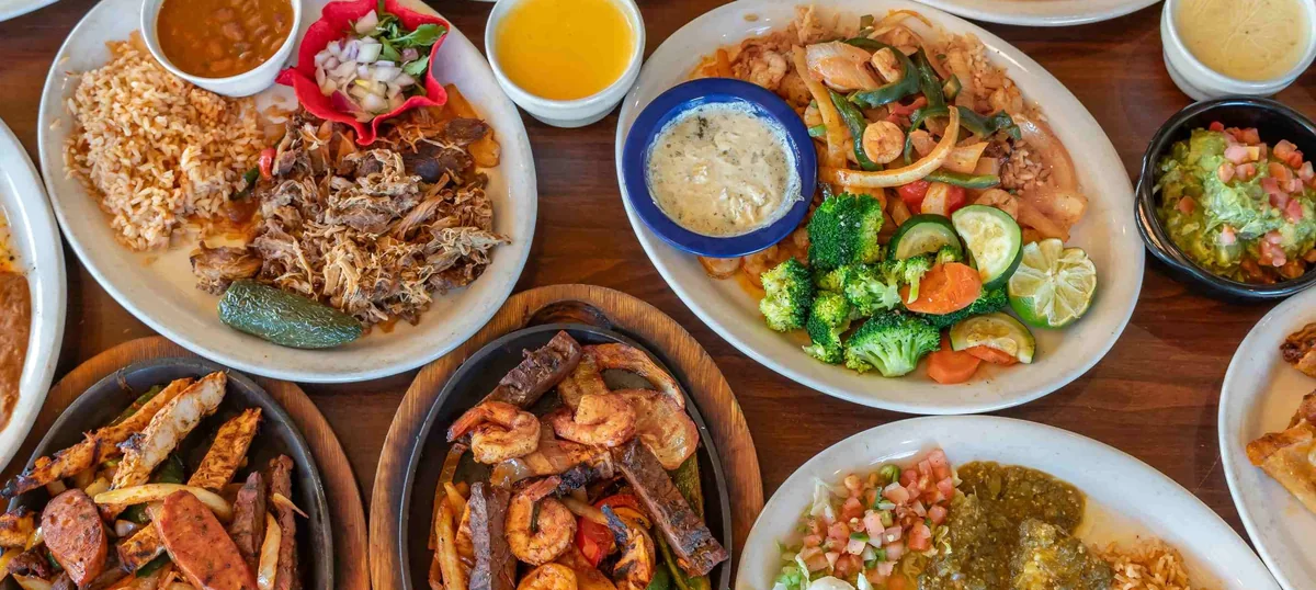 A table spread of fajitas, rice, beans and enchiladas at MasFajitas in Round Rock