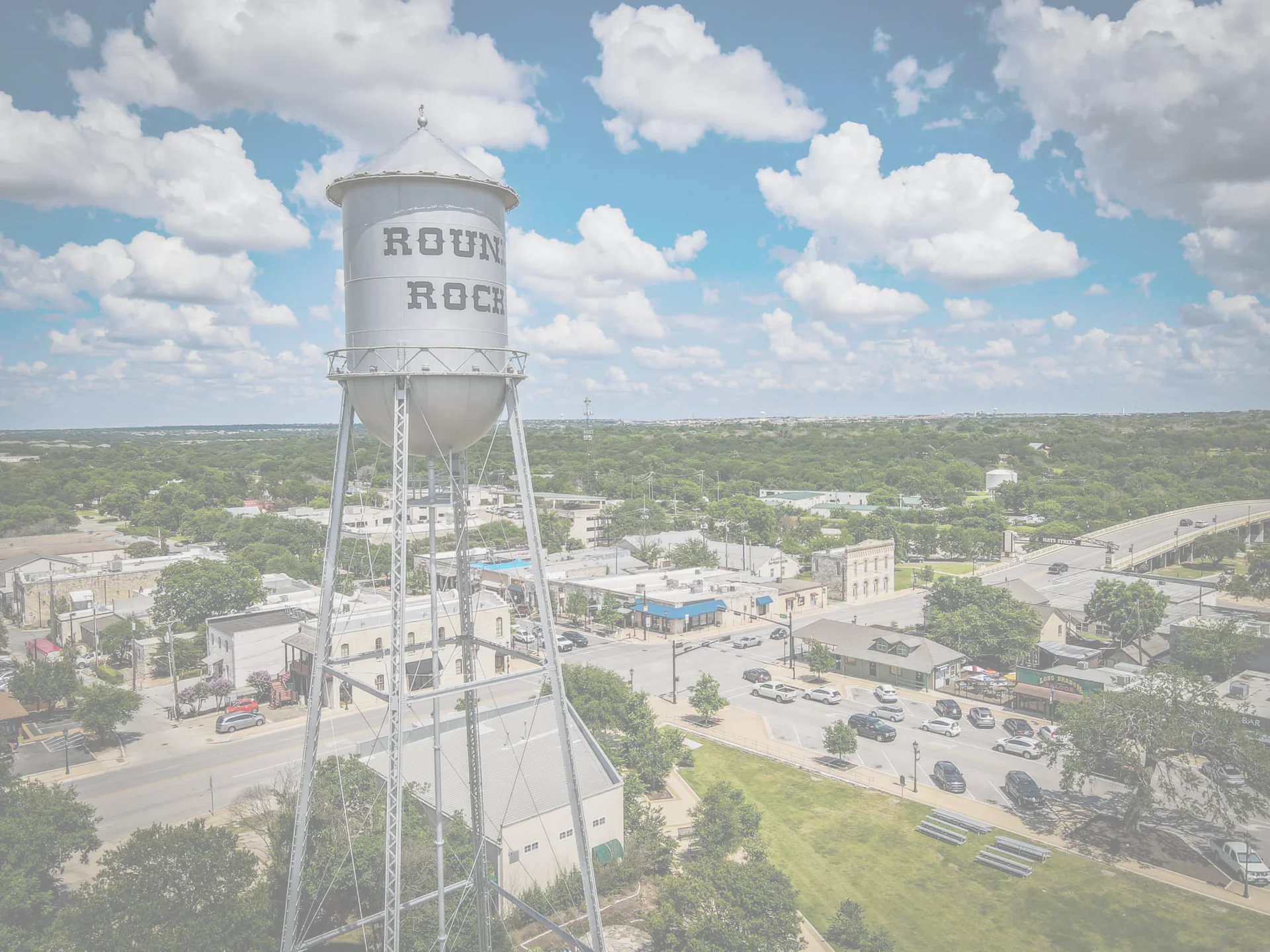 The Round Rock water tower above the downtown street grid, seen from the air