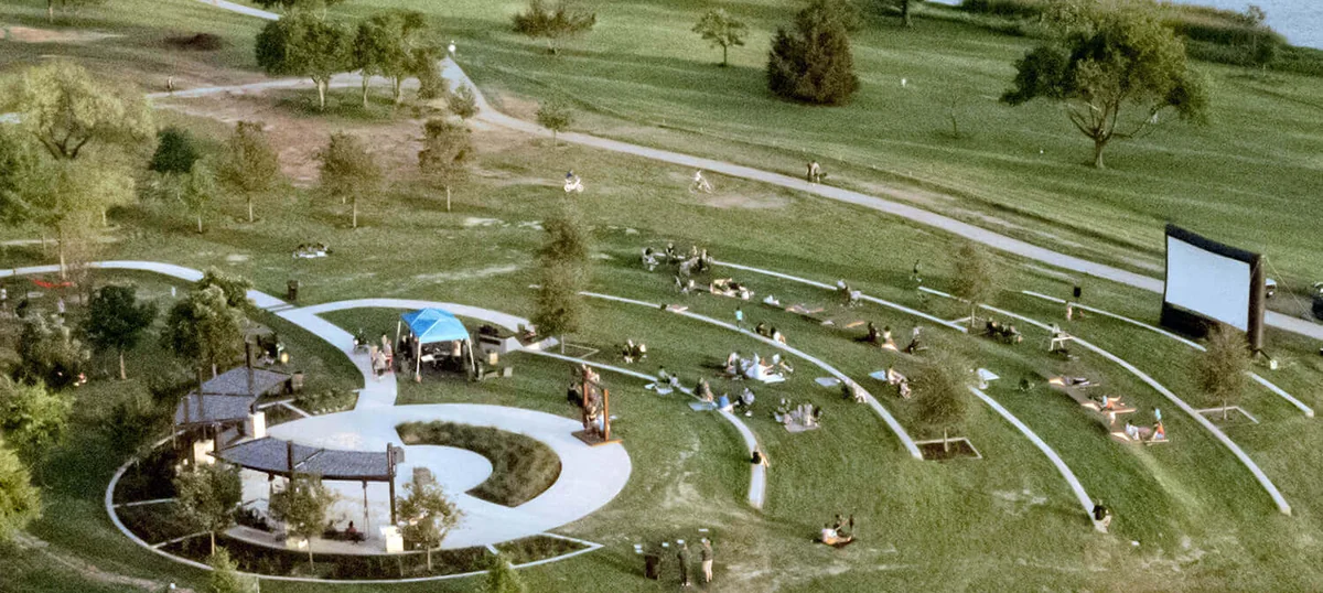 Aerial view of a Round Rock park amphitheatre, its terraced lawn and the lake beyond