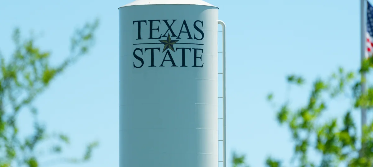 The Texas State University wordmark on the water tower at the Round Rock campus
